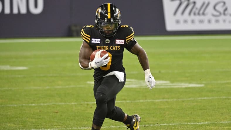 Jun 18, 2023; Toronto, Ontario, CAN; Hamilton
Tiger-Cats running back James Butler (9) runs with the ball against the Toronto Argonauts in the fourth quarter at BMO Field. Mandatory Credit: Dan Hamilton-USA TODAY Sports
