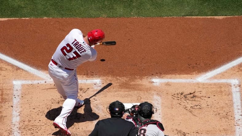 Jul 2, 2023; Anaheim, California, USA; Los Angeles Angels center fielder Mike Trout (27) hits a solo home run in the first inning against the Arizona Diamondbacks at Angel Stadium. Mandatory Credit: Kirby Lee-USA TODAY Sports