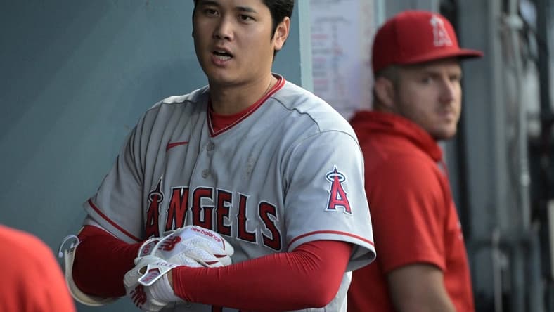 Jul 8, 2023; Los Angeles, California, USA; Los Angeles Angels designated hitter Shohei Ohtani (17) and center fielder Mike Trout (27) look on from the dugout during the game against the Los Angeles Dodgers at Dodger Stadium. Mandatory Credit: Jayne Kamin-Oncea-USA TODAY Sports