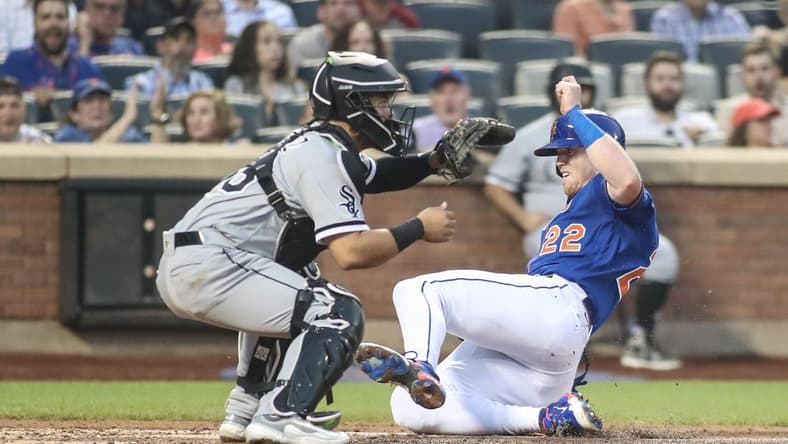 Jul 19, 2023; New York City, New York, USA; New York Mets third baseman Brett Baty (22) slides safely past Chicago White Sox catcher Carlos Perez (36) in the fourth inning at Citi Field. Mandatory Credit: Wendell Cruz-USA TODAY Sports