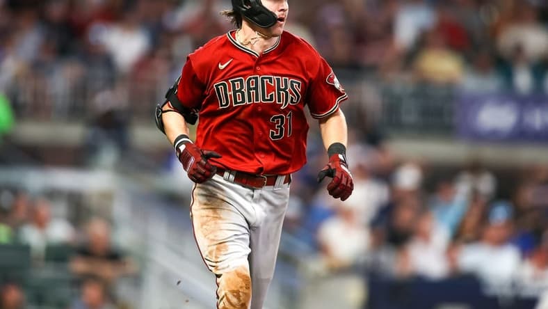 Jul 19, 2023; Atlanta, Georgia, USA; Arizona Diamondbacks right fielder Jake McCarthy (31) hits a single against the Atlanta Braves in the ninth inning at Truist Park. Mandatory Credit: Brett Davis-USA TODAY Sports