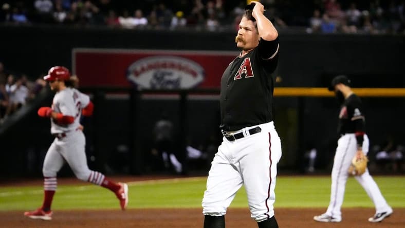 Jul 24, 2023; Phoenix, AZ, USA; Arizona Diamondbacks relief pitcher Andrew Chafin (57) reacts after walking in the winning run against the St. Louis Cardinals in the ninth inning at Chase Field. Mandatory Credit: Rob Schumacher-Arizona Republic