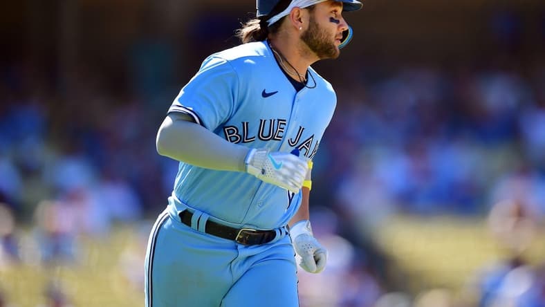 Jul 26, 2023; Los Angeles, California, USA; Toronto Blue Jays shortstop Bo Bichette (11) runs after hitting a two run RBI single against the Los Angeles Dodgers during the eighth inning at Dodger Stadium. Mandatory Credit: Gary A. Vasquez-USA TODAY Sports