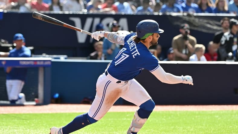 Jul 29, 2023; Toronto, Ontario, CAN;  Toronto Blue Jays shortstop Bo Bichette (11) hits a double against the Los Angeles Angels in the fifth inning at Rogers Centre. Mandatory Credit: Dan Hamilton-USA TODAY Sports