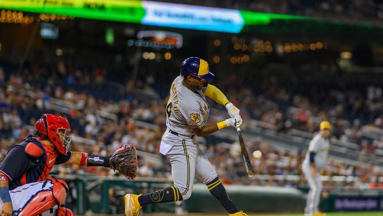Jul 31, 2023; Washington, District of Columbia, USA; Milwaukee Brewers third baseman Andruw Monasterio (14) hits a single during the sixth inning against the Washington Nationals at Nationals Park. Mandatory Credit: Reggie Hildred-USA TODAY Sports