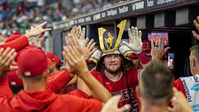 Jul 31, 2023; Cumberland, Georgia, USA; Los Angeles Angels catcher Chad Wallach (35) reacts with teammates in the dugout after hitting a home run against the Atlanta Braves during the sixth inning at Truist Park. Mandatory Credit: Dale Zanine-USA TODAY Sports