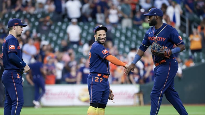 Jul 31, 2023; Houston, Texas, USA; Houston Astros third baseman Alex Bregman (2) and second baseman Jose Altuve (27) and  left fielder Yordan Alvarez (44) celebrate the win against the Cleveland Guardians  after defeating the Cleveland Guardians at Minute Maid Park. Mandatory Credit: Thomas Shea-USA TODAY Sports