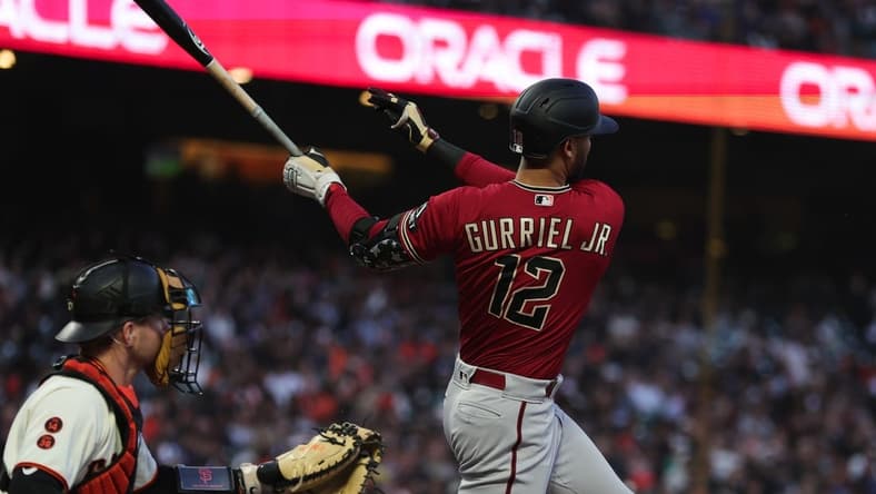 Jul 31, 2023; San Francisco, California, USA; Arizona Diamondbacks left fielder Lourdes Gurriel Jr. (12) hits an RBI single during the sixth inning against the San Francisco Giants at Oracle Park. Mandatory Credit: Sergio Estrada-USA TODAY Sports