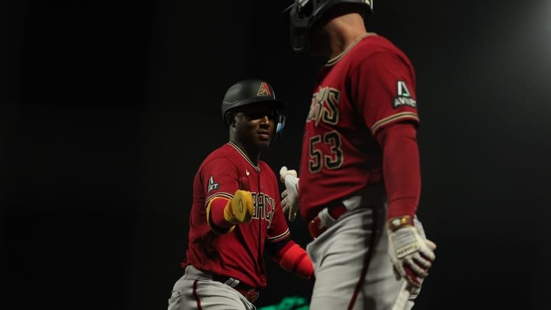 Jul 31, 2023; San Francisco, California, USA; Arizona Diamondbacks shortstop Geraldo Perdomo (2) is congratulated by first baseman Christian Walker (53) after scoring a run during the eleventh inning against the San Francisco Giants at Oracle Park. Mandatory Credit: Sergio Estrada-USA TODAY Sports