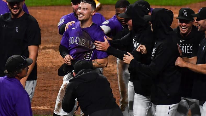 Jul 31, 2023; Denver, Colorado, USA; Colorado Rockies center fielder Brenton Doyle (9) is congratulated by teammates after scoring the winning run in the 10th inning over over the San Diego Padres at Coors Field. Mandatory Credit: John Leyba-USA TODAY Sports