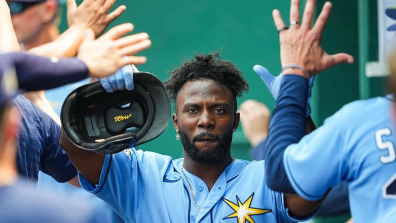 Jul 15, 2023; Kansas City, Missouri, USA; Tampa Bay Rays left fielder Randy Arozarena (56) is congratulated by teammates after scoring a run during the eighth inning against the Kansas City Royals at Kauffman Stadium. Mandatory Credit: Jay Biggerstaff-USA TODAY Sports