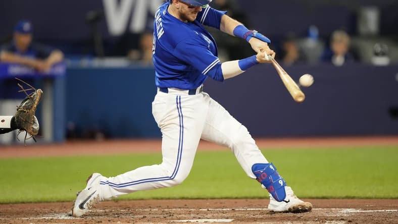 Aug 1, 2023; Toronto, Ontario, CAN; Toronto Blue Jays catcher Danny Jansen (9) hits a two run home run against the Baltimore Orioles during the second inning at Rogers Centre. Mandatory Credit: John E. Sokolowski-USA TODAY Sports