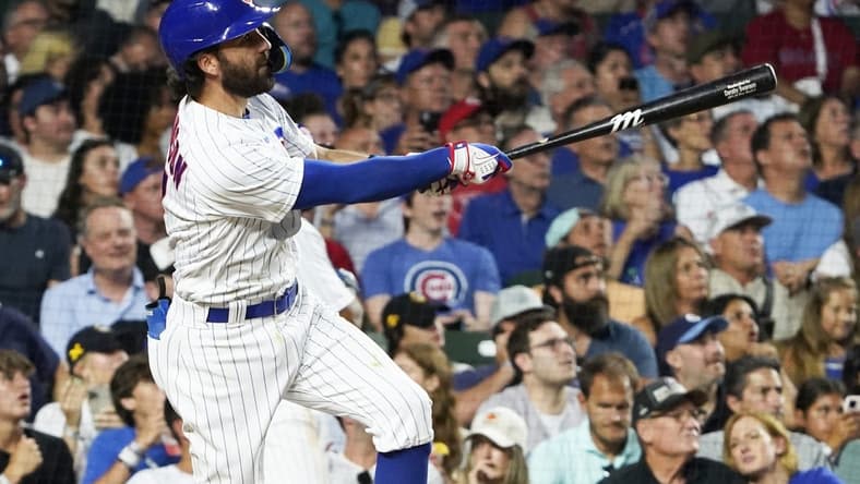 Aug 1, 2023; Chicago, Illinois, USA; Chicago Cubs shortstop Dansby Swanson (7) hits a two-run homer against the Cincinnati Reds during the fourth inning at Wrigley Field. Mandatory Credit: David Banks-USA TODAY Sports