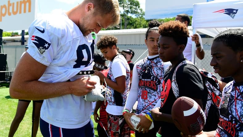 Aug 1, 2023; Foxborough, MA, USA; New England Patriots tight end Mike Gesicki (88) signs an autograph for a fan at training camp at Gillette Stadium. Mandatory Credit: Eric Canha-USA TODAY Sports