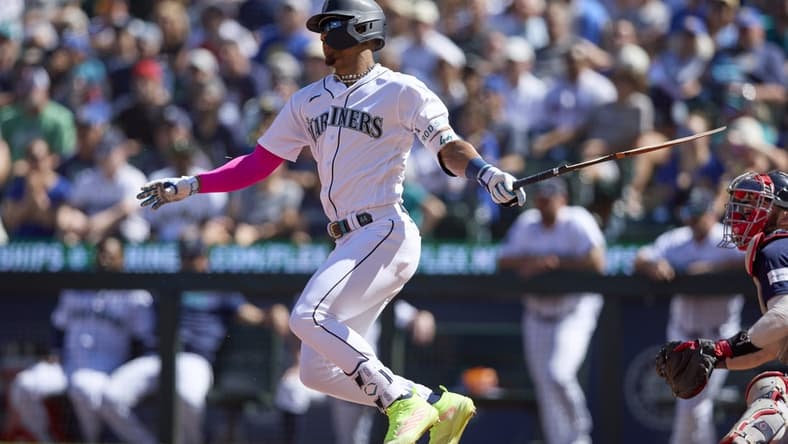 Julio Rodriguez breaks his bat hitting an RBI single against the Boston Red Sox during the seventh inning at T-Mobile Park.