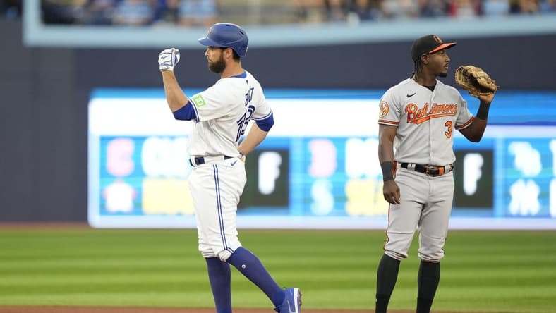 Aug 2, 2023; Toronto, Ontario, CAN; Toronto Blue Jays first baseman Brandon Belt (13) gestures to his dugout after hitting a double against the Baltimore Orioles during the fourth inning at Rogers Centre. Mandatory Credit: John E. Sokolowski-USA TODAY Sports