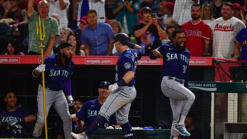 August 3, 2023; Anaheim, California, USA; Seattle Mariners left fielder Cade Marlowe (18) is greeted by shortstop J.P. Crawford (3) and designated hitter Teoscar Hernandez (35) after hitting a grand slam home run against the Los Angeles Angels during the ninth inning at Angel Stadium. Mandatory Credit: Gary A. Vasquez-USA TODAY Sports