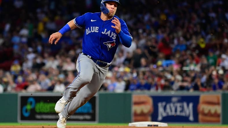 Aug 4, 2023; Boston, Massachusetts, USA; Toronto Blue Jays center fielder Daulton Varsho (25) scores on an RBI by right fielder George Springer (4) during the fourth inning against the Boston Red Sox at Fenway Park. Mandatory Credit: Eric Canha-USA TODAY Sports