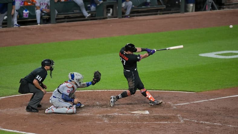 Aug 4, 2023; Baltimore, Maryland, USA; Baltimore Orioles catcher James McCann (27)hits a two run double during the sixth inning against the New York Mets at Oriole Park at Camden Yards. Mandatory Credit: Tommy Gilligan-USA TODAY Sports