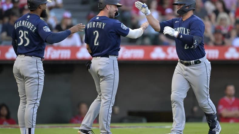 Aug 4, 2023; Anaheim, California, USA;  Seattle Mariners first baseman Ty France (23) is greeted by right fielder Teoscar Hernandez (35) and catcher Tom Murphy (2) after hitting a three run home run in the first inning against the Los Angeles Angels at Angel Stadium. Mandatory Credit: Jayne Kamin-Oncea-USA TODAY Sports