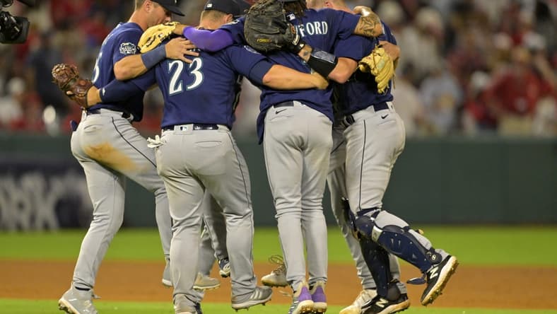 Aug 4, 2023; Anaheim, California, USA;  Seattle Mariners players dance in a circle after defeating the Los Angeles Angels at Angel Stadium. Mandatory Credit: Jayne Kamin-Oncea-USA TODAY Sports