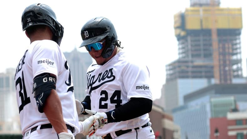 Detroit Tigers Miguel Cabrera shakes hands with teammate Riley Greene after scoring the Tigers first run during game action on Fiesta Tigres between the Detroit Tigers and the Tampa Bay Rays at Comerica Park in Detroit on Saturday, August 5, 2023.