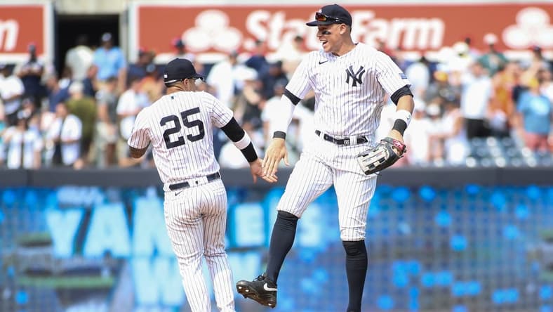 Aug 5, 2023; Bronx, New York, USA;  New York Yankees second baseman Gleyber Torres (25) and right fielder Aaron Judge (99) celebrate after defeating the Houston Astros 3-1 at Yankee Stadium. Mandatory Credit: Wendell Cruz-USA TODAY Sports