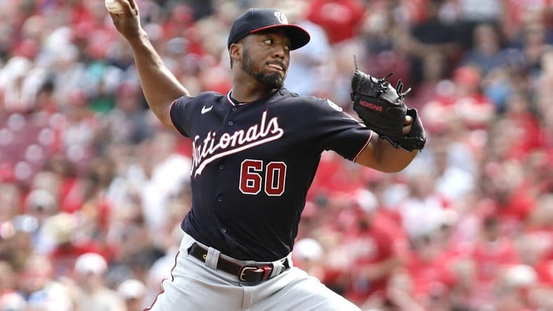 Aug 5, 2023; Cincinnati, Ohio, USA; Washington Nationals Joan Adon (60) throws against the Cincinnati Reds during the second inning at Great American Ball Park. Mandatory Credit: David Kohl-USA TODAY Sports