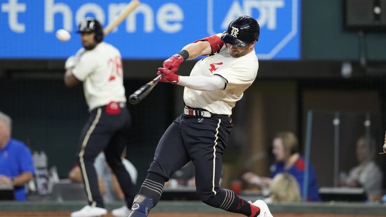 Aug 5, 2023; Arlington, Texas, USA; Texas Rangers designated hitter Robbie Grossman (4) hits an three-run home run against the Miami Marlins during the fourth inning at Globe Life Field. Mandatory Credit: Jim Cowsert-USA TODAY Sports