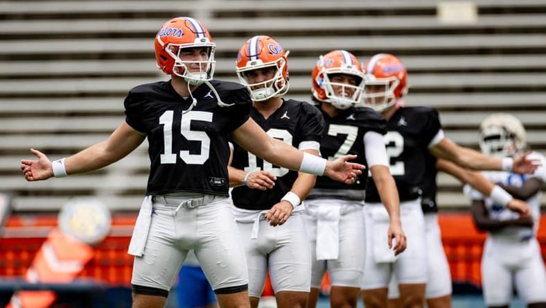 Florida Gators quarterback Graham Mertz (15) stretches with Florida Gators quarterback Jack Miller III (10) and Florida Gators quarterback Max Brown (17) during fall football practice at Ben Hill Griffin Stadium at the University of Florida in Gainesville, FL on Saturday, August 5, 2023. [Matt Pendleton/Gainesville Sun]