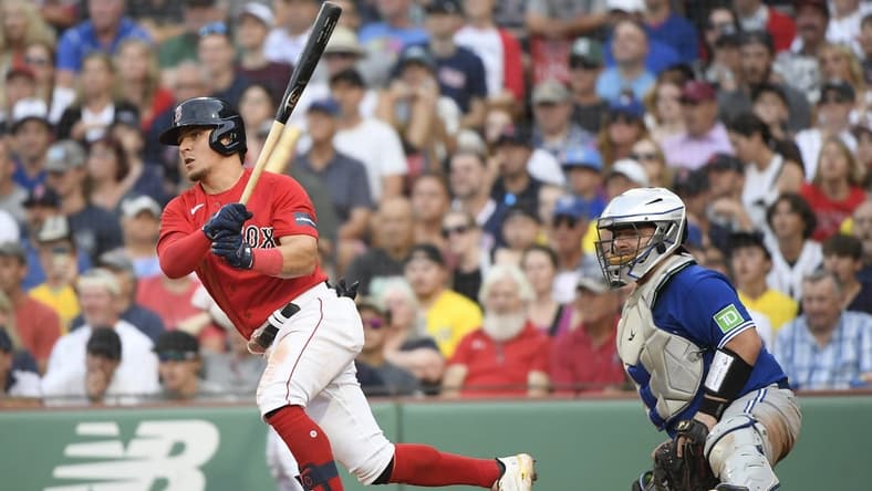 Aug 5, 2023; Boston, Massachusetts, USA;  Boston Red Sox third baseman Luis Urias (17) hits an RBI single during the ninth inning against the Toronto Blue Jays at Fenway Park. Mandatory Credit: Bob DeChiara-USA TODAY Sports