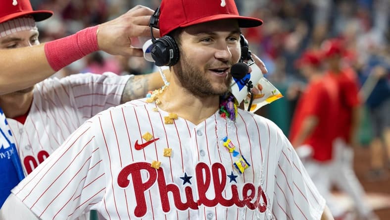 Aug 5, 2023; Philadelphia, Pennsylvania, USA; Philadelphia Phillies shortstop Trea Turner (7) has food and gum and water dumped on him during an interview after a victory against the Kansas City Royals at Citizens Bank Park. Mandatory Credit: Bill Streicher-USA TODAY Sports