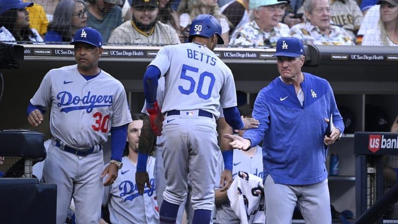 Aug 4, 2023; San Diego, California, USA; Los Angeles Dodgers right fielder Mookie Betts (50) is congratulated at the dugout after scoring a run against the San Diego Padres during the fifth inning at Petco Park. Mandatory Credit: Orlando Ramirez-USA TODAY Sports