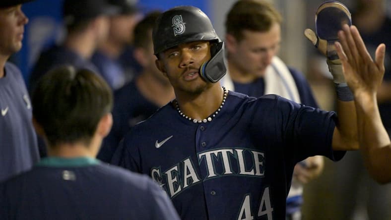 Aug 5, 2023; Anaheim, California, USA;  Seattle Mariners center fielder Julio Rodriguez (44) is congratulated in the dugout after scoring a run in the eighth inning against the Los Angeles Angels at Angel Stadium. Mandatory Credit: Jayne Kamin-Oncea-USA TODAY Sports