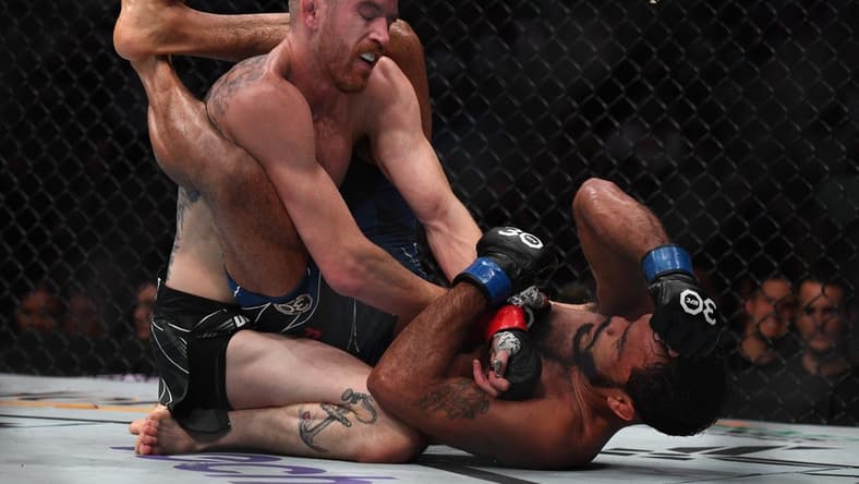 Aug 5, 2023; Nashville, Tennessee, USA;  Cory Sandhagen (red gloves) fights Rob Font (blue gloves) during UFC Fight Night at Bridgestone Arena. Mandatory Credit: Christopher Hanewinckel-USA TODAY Sports