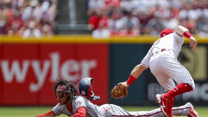 Aug 6, 2023; Cincinnati, Ohio, USA; Cincinnati Reds second baseman Matt McLain (9) attempts to tag out Washington Nationals shortstop CJ Abrams (5) at second in the second inning at Great American Ball Park. Mandatory Credit: Katie Stratman-USA TODAY Sports