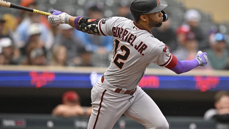 Aug 6, 2023; Minneapolis, Minnesota, USA; Arizona Diamondbacks outfielder Lourdes Gurriel (12) hits a double against the Minnesota Twins during the seventh inning at Target Field. Mandatory Credit: Nick Wosika-USA TODAY Sports