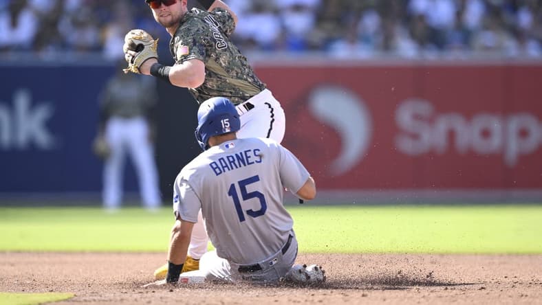 Aug 6, 2023; San Diego, California, USA; San Diego Padres second baseman Jake Cronenworth (9) forces out Los Angeles Dodgers catcher Austin Barnes (15) at second base during the third inning at Petco Park. Mandatory Credit: Orlando Ramirez-USA TODAY Sports