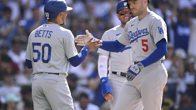Aug 6, 2023; San Diego, California, USA; Los Angeles Dodgers first baseman Freddie Freeman (5) is congratulated by right fielder Mookie Betts (50) after hitting a two-run home run during the second inning against the San Diego Padres at Petco Park. Mandatory Credit: Orlando Ramirez-USA TODAY Sports