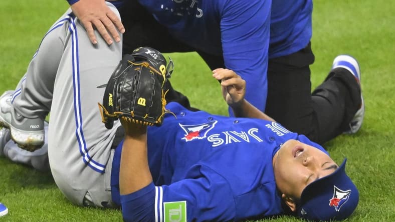 Aug 7, 2023; Cleveland, Ohio, USA; Toronto Blue Jays starting pitcher Hyun Jin Ryu (99) reacts after he was hit by a batted ball in the fourth inning against the Cleveland Guardians at Progressive Field. Mandatory Credit: David Richard-USA TODAY Sports