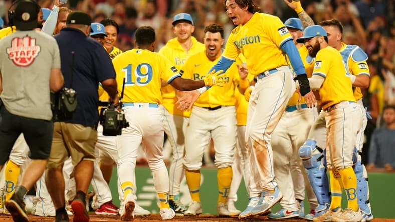 Aug 7, 2023; Boston, Massachusetts, USA; Boston Red Sox shortstop Pablo Reyes (19) is greeted at home plate after hitting a home run with the bases loaded to end the game against the Kansas City Royals in the ninth inning at Fenway Park. Mandatory Credit: David Butler II-USA TODAY Sports