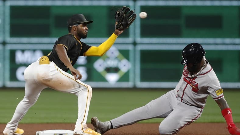 Aug 7, 2023; Pittsburgh, Pennsylvania, USA; Atlanta Braves designated hitter Marcell Ozuna (right) steals second base as Pittsburgh Pirates second baseman Liover Peguero (left) takes the throw during the sixth inning at PNC Park. Mandatory Credit: Charles LeClaire-USA TODAY Sports