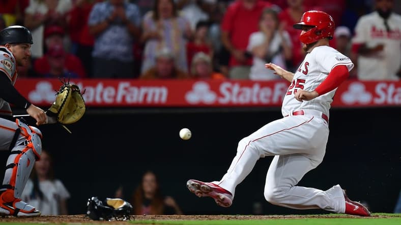 Aug 7, 2023; Anaheim, California, USA; Los Angeles Angels first baseman C.J. Cron scores a run against San Francisco Giants catcher Patrick Bailey (14) during the sixth inning at Angel Stadium. Mandatory Credit: Gary A. Vasquez-USA TODAY Sports