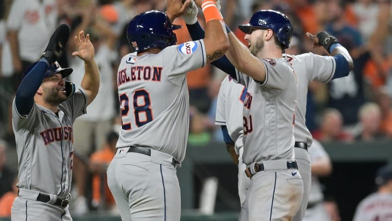 Aug 8, 2023; Baltimore, Maryland, USA; Houston Astros right fielder Kyle Tucker (30) celebrates with pinch hitter John Singleton (28) and second baseman Jose Altuve (27) at home pate after hitting a grand slam in the ninth inning against the Baltimore Orioles  at Oriole Park at Camden Yards. Mandatory Credit: Tommy Gilligan-USA TODAY Sports