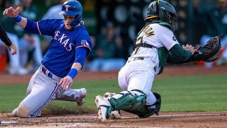 Aug 8, 2023; Oakland, California, USA;  Texas Rangers catcher Sam Huff (55) scores on a single hit by Texas Rangers second baseman Marcus Semien (not pictured) against the Oakland Athletics during the fourth inning at Oakland-Alameda County Coliseum. Mandatory Credit: Neville E. Guard-USA TODAY Sports