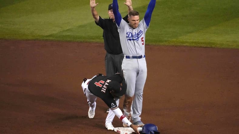 Aug 8, 2023; Phoenix, Arizona, USA; Los Angeles Dodgers first baseman Freddie Freeman (5) beats the tag of Arizona Diamondbacks second baseman Ketel Marte (4) for an RBI double during the fifth inning at Chase Field. Mandatory Credit: Joe Camporeale-USA TODAY Sports