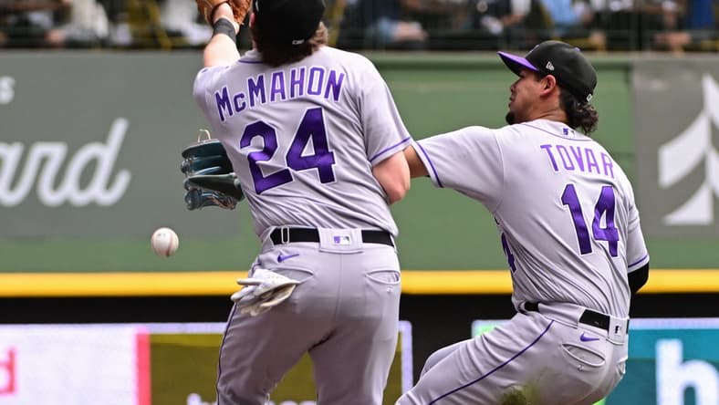 Aug 9, 2023; Milwaukee, Wisconsin, USA; Colorado Rockies shortstop Ezequiel Tovar (14) and third baseman Ryan McMahon (24) cannot catch a foul ball hit by Milwaukee Brewers right fielder Sal Frelick (not pictured) in the fifth inning at American Family Field. Mandatory Credit: Benny Sieu-USA TODAY Sports
