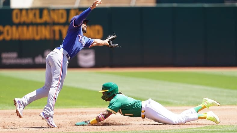 Aug 9, 2023; Oakland, California, USA; Oakland Athletics center fielder Esteury Ruiz (1) steals second base against Texas Rangers second baseman Marcus Semien (2) in the third inning at Oakland-Alameda County Coliseum. Mandatory Credit: Cary Edmondson-USA TODAY Sports