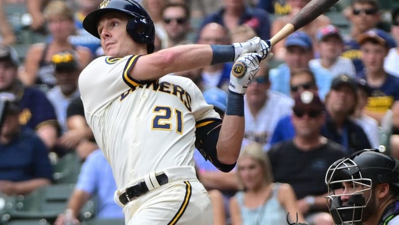 Aug 9, 2023; Milwaukee, Wisconsin, USA;  Milwaukee Brewers first baseman Mark Canha (21) hits a double to drive in a run in the tenth inning against the Colorado Rockies at American Family Field. Mandatory Credit: Benny Sieu-USA TODAY Sports