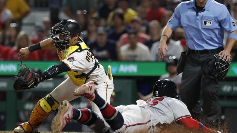 Aug 9, 2023; Pittsburgh, Pennsylvania, USA; Atlanta Braves center fielder Michael Harris II (right) scores a run past Pittsburgh Pirates catcher Endy Rodriguez (25) during the eighth inning at PNC Park. Mandatory Credit: Charles LeClaire-USA TODAY Sports